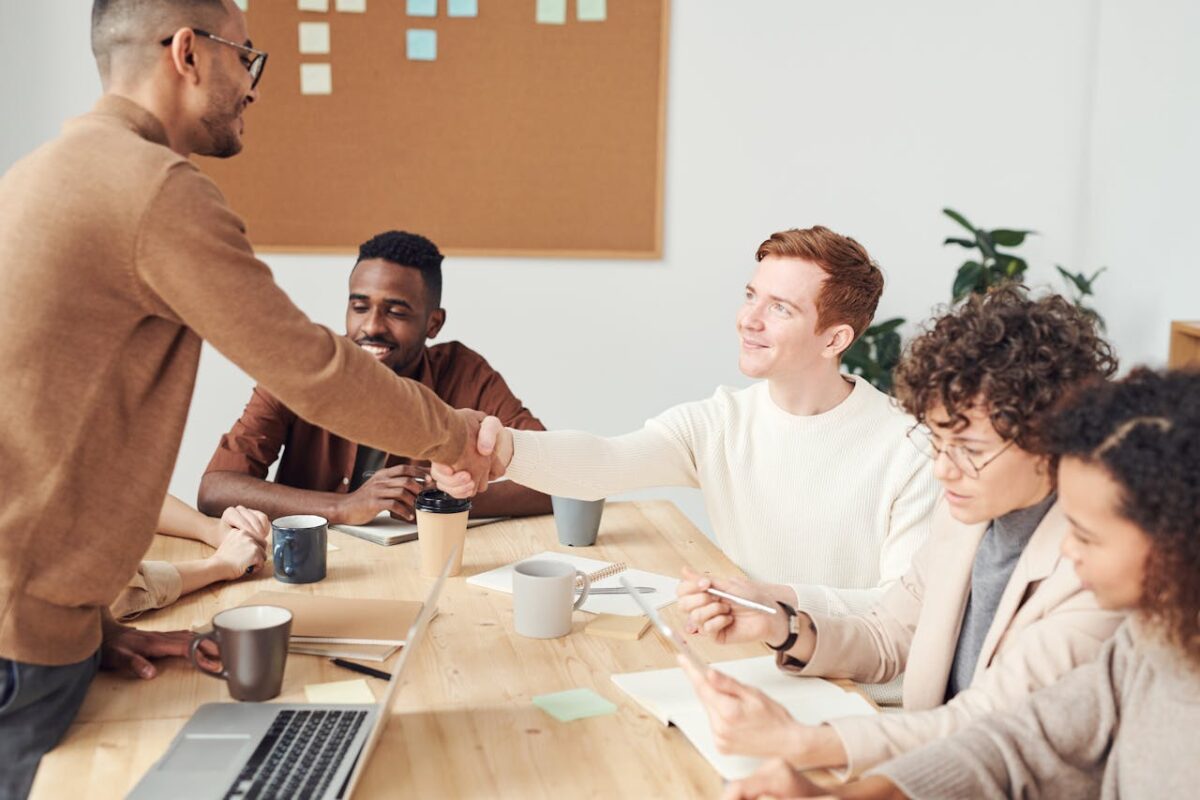 A diverse team in a modern office working together on a project, showcasing teamwork and collaboration.